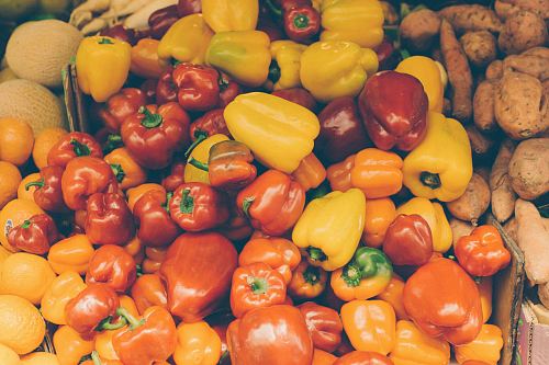 flat lay photography of bunch of yellow and red bell peppers